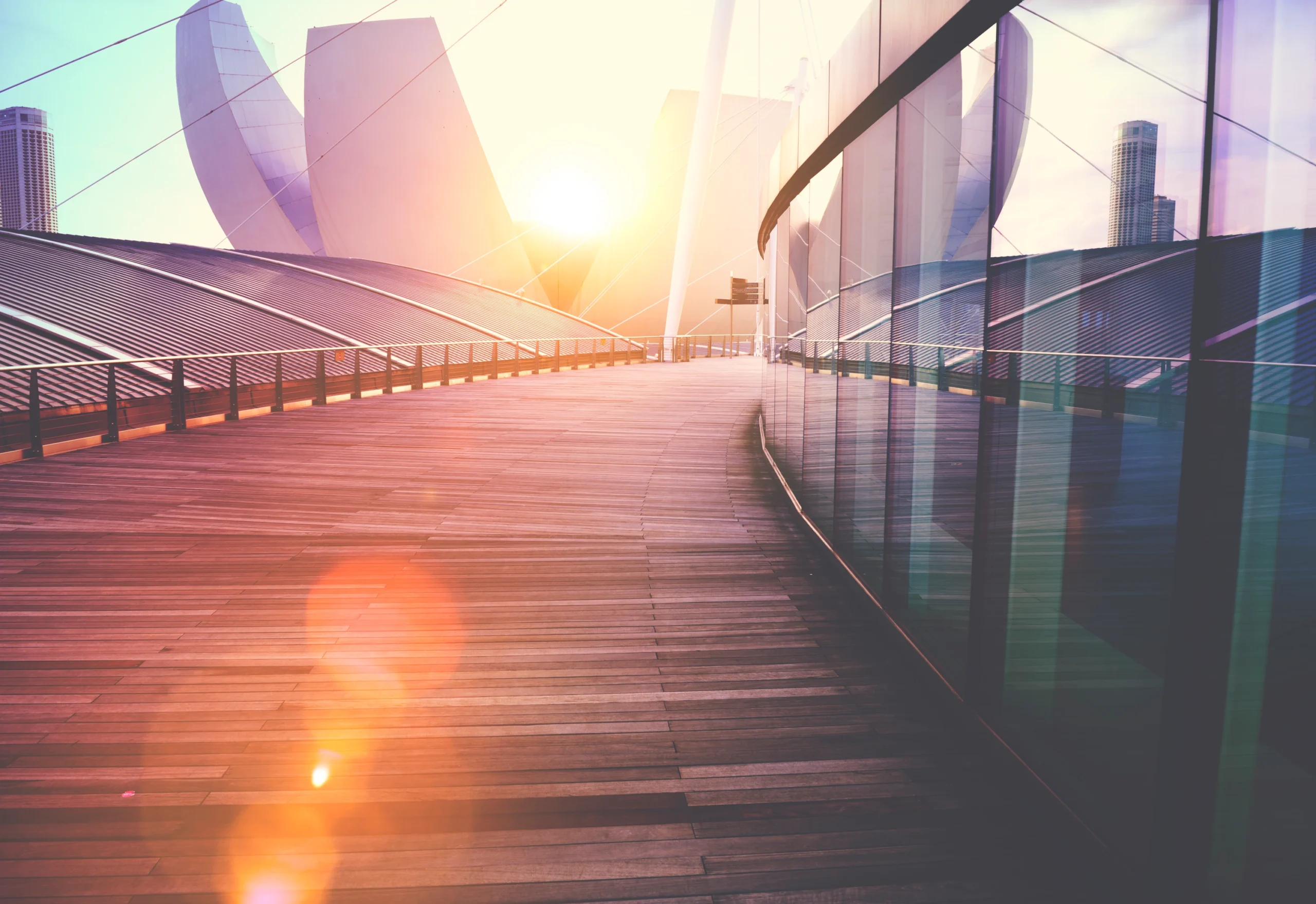 Contemporary architecture and a sunlit waterfront walkway